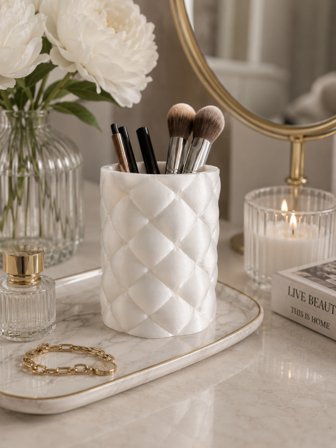 Pearl white quilted vanity organizer from the Luxe Living Collection styled with makeup brushes and luxury décor.